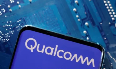 Qualcomm logo on smartphone, circuit board background