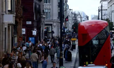 Busy London street with red bus and pedestrians.