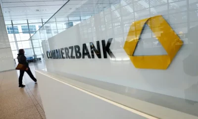 Commerzbank building interior with logo and woman walking.