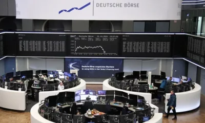 Deutsche Börse trading floor with digital stock displays.