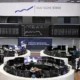 Deutsche Börse trading floor with digital stock displays.