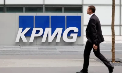 Man walking past KPMG office building