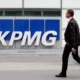 Man walking past KPMG office building