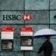 Person with umbrella at HSBC cash machines.