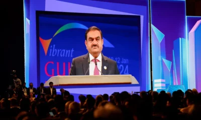 Speaker at Vibrant Gujarat 2024 event on stage.