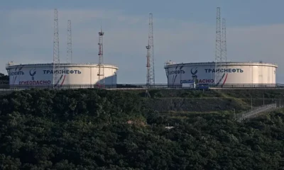 Large oil storage tanks with antennas nearby.