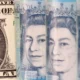 Close-up of US dollar and UK pound notes.