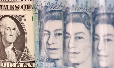 US dollar and UK pound currency notes closeup.