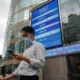 Man on phone outside stock exchange building