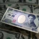 1000 yen note among US dollars.