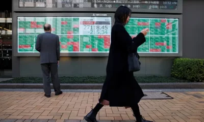 Tokyo stock market display board showing data.