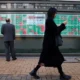 Tokyo stock market display board showing data.