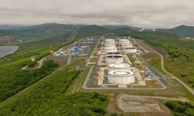 Aerial view of oil refinery in lush landscape.