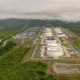 Aerial view of oil refinery in lush landscape.