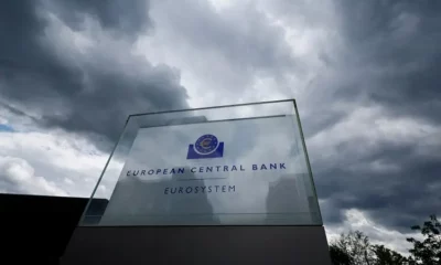 European Central Bank sign under cloudy sky.