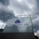 European Central Bank sign under cloudy sky.