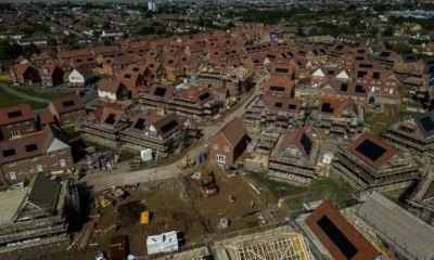 Aerial view of houses under construction in a neighbourhood.