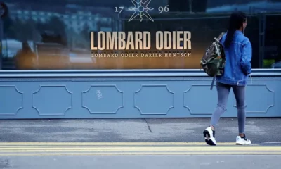 Person walking past Lombard Odier window display.