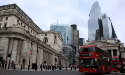 Red bus in London's financial district skyline