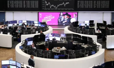 Frankfurt Stock Exchange trading floor with digital screens.