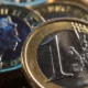 Close-up of Euro and Pound coins.