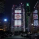 Illuminated skyscrapers in city skyline at night.