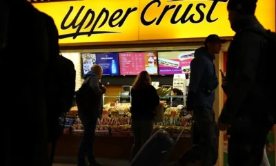 People at Upper Crust bakery in train station