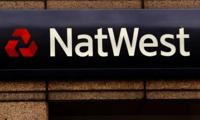 NatWest bank sign on building wall.