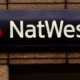 NatWest bank sign on building wall.