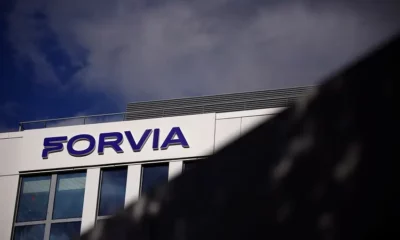 Forvia building with cloudy sky background.