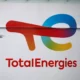 TotalEnergies logo on building with passing bird