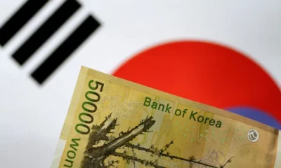 Korean won banknote with South Korea flag background.