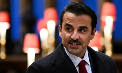 Man in suit and tie with blurred background.