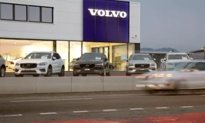 Volvo dealership with parked cars and showroom display.