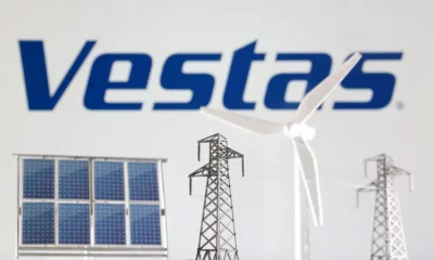 Vestas logo with solar panel and wind turbine.