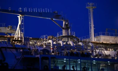 Industrial ship deck at night with pipes.