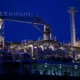 Industrial ship deck at night with pipes.