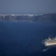 Cruise ship near Santorini island coastline in Greece.