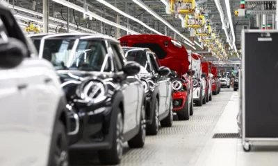 Cars on automated assembly line in factory