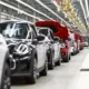 Cars on automated assembly line in factory