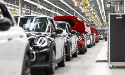 Mini cars on assembly line at factory