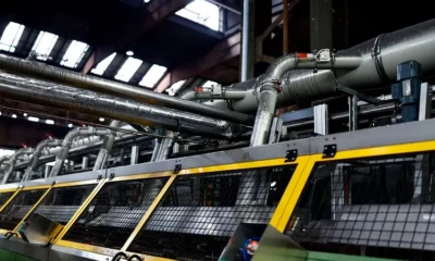 Industrial machinery with large metal pipes inside factory