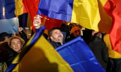 People holding Romanian flags at a gathering