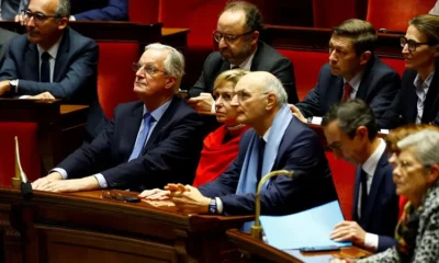 Politicians attentively listening in a parliamentary session.