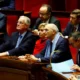 Politicians attentively listening in a parliamentary session.