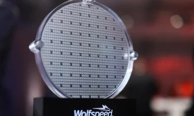 Silicon carbide wafer displayed on stand.