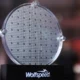 Silicon carbide wafer displayed on stand.