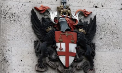 City of London coat of arms on stone wall.