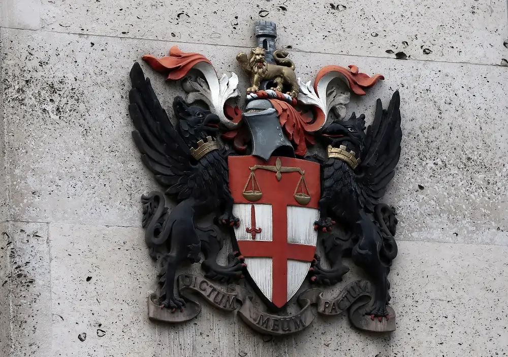 City of London coat of arms on stone wall.