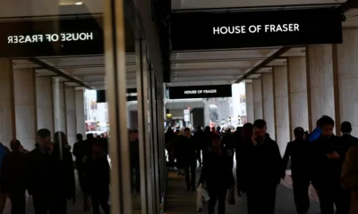 People walking near House of Fraser store entrance.